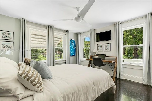 bedroom with multiple windows, ceiling fan, and dark wood-type flooring