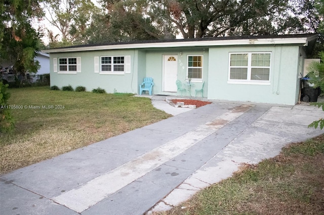 ranch-style home featuring a front yard