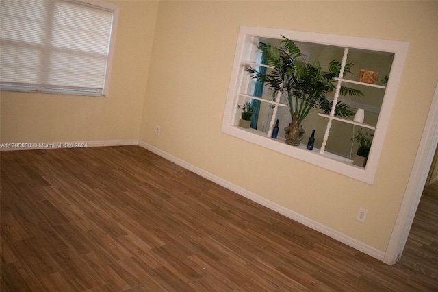 spare room with dark wood-type flooring