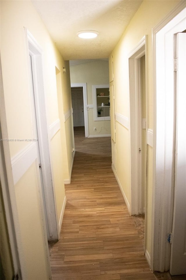 hallway with light hardwood / wood-style flooring