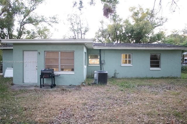 rear view of property featuring central air condition unit