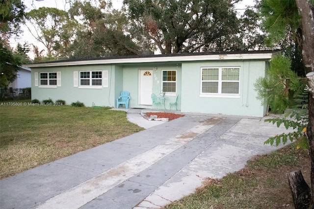 ranch-style home featuring a front yard