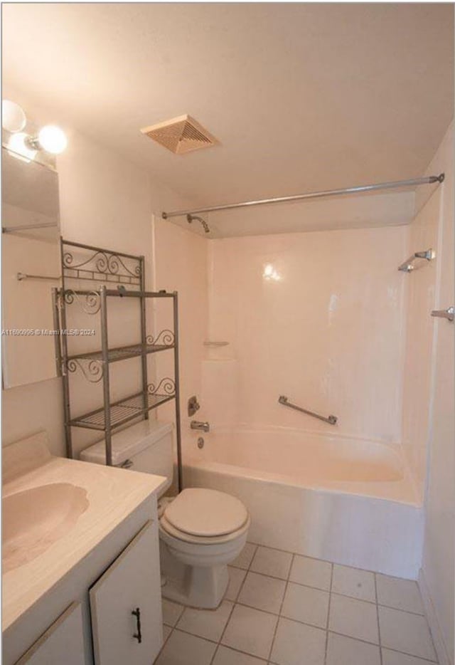 full bathroom featuring toilet, vanity, tile patterned floors, and tub / shower combination