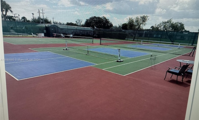 view of tennis court featuring basketball hoop