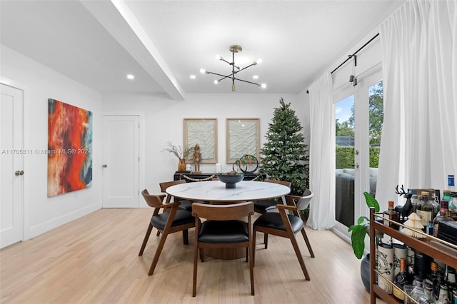 dining room with an inviting chandelier and light wood-type flooring