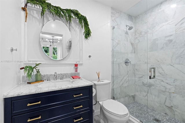 bathroom with walk in shower, vanity, and toilet