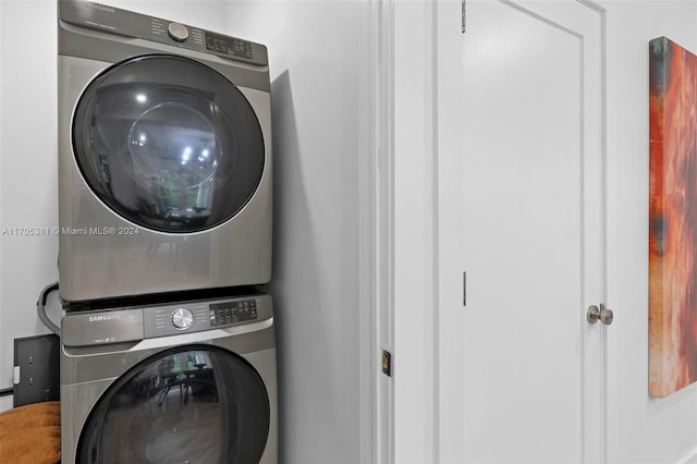 washroom featuring stacked washing maching and dryer