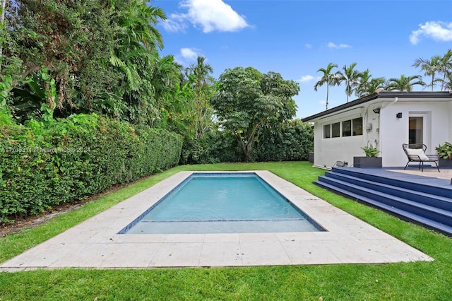 view of swimming pool with a lawn and a patio area