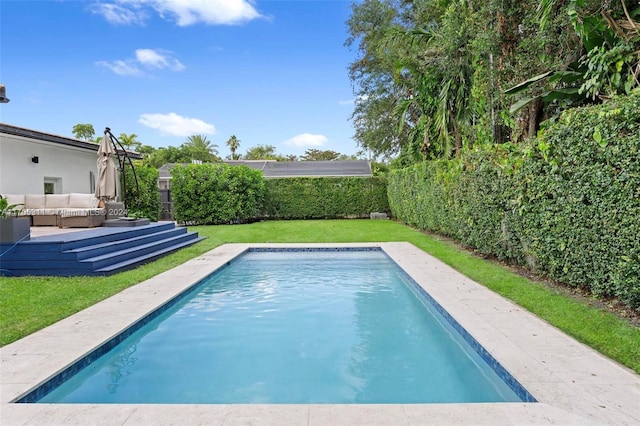 view of swimming pool featuring a lawn and outdoor lounge area