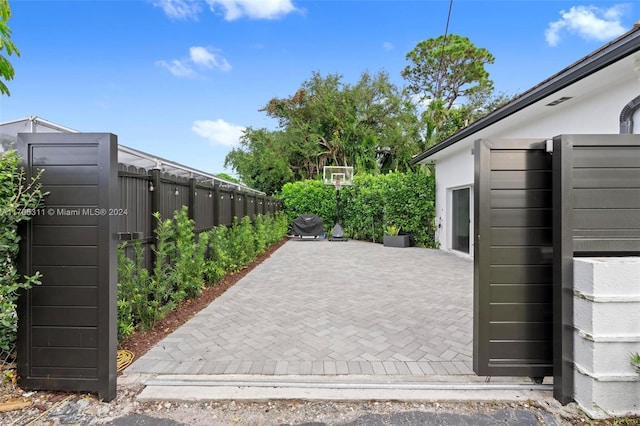 view of gate with a patio