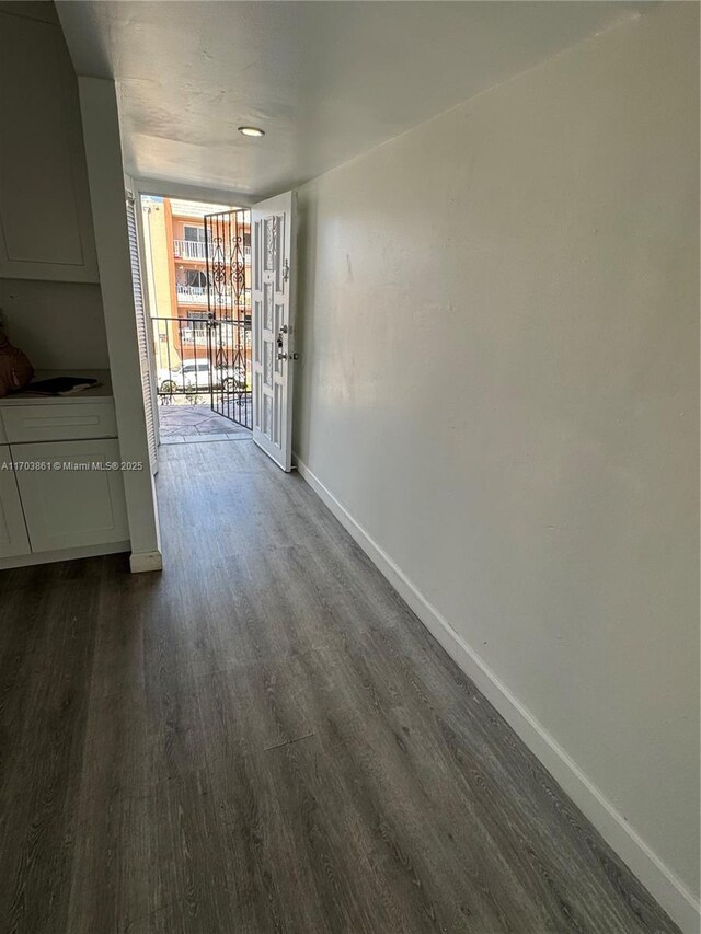 unfurnished room with ceiling fan, wood-type flooring, and a textured ceiling