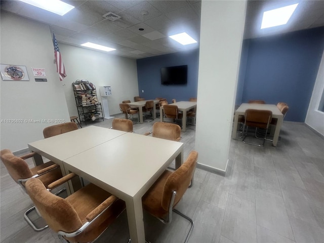 dining space with a paneled ceiling