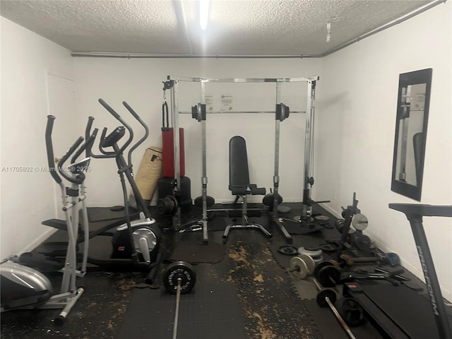 exercise room with a textured ceiling