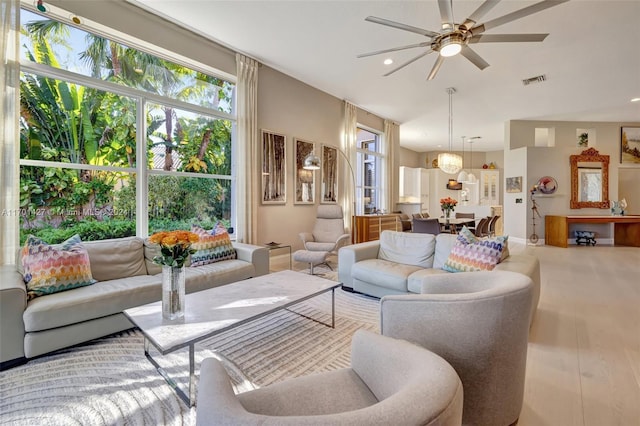 living room with ceiling fan and hardwood / wood-style floors