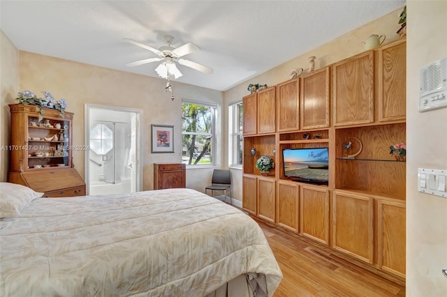 bedroom featuring ensuite bathroom, light hardwood / wood-style flooring, and ceiling fan