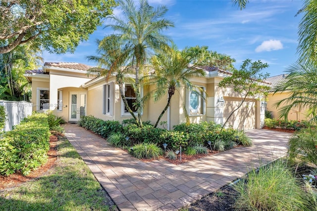 mediterranean / spanish-style house with a garage