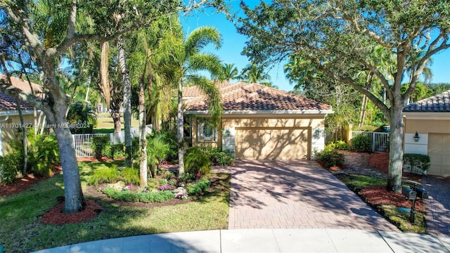 mediterranean / spanish-style home with a garage and a front lawn