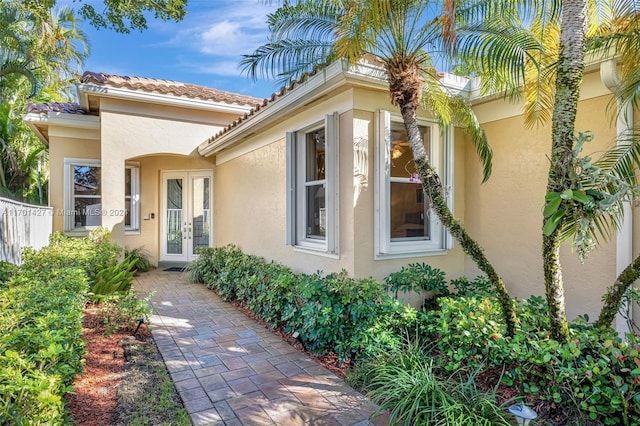 view of exterior entry featuring french doors