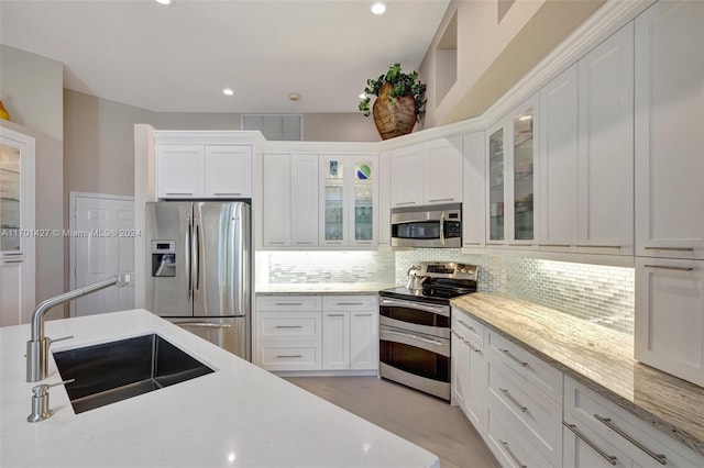 kitchen featuring white cabinets, sink, and appliances with stainless steel finishes