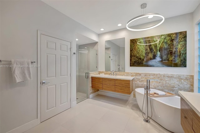 bathroom with tile patterned floors, vanity, and plus walk in shower