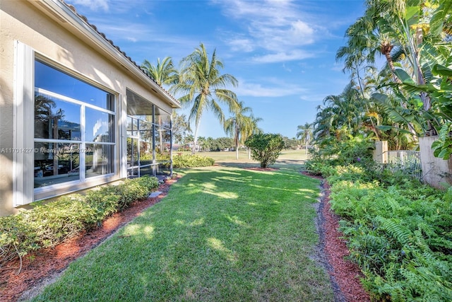 view of yard featuring a sunroom