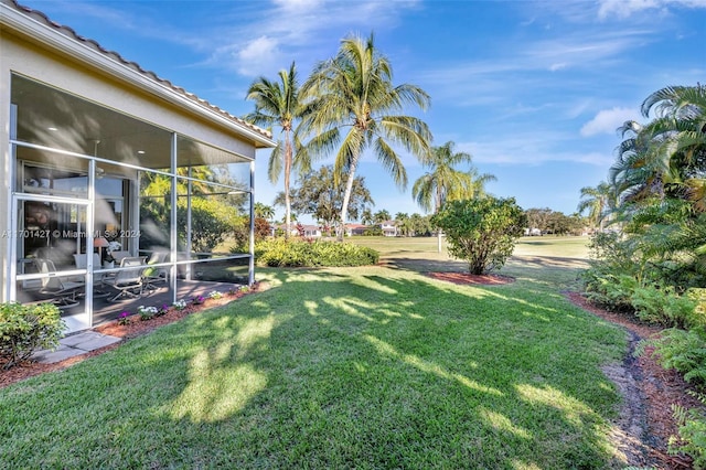 view of yard with a sunroom