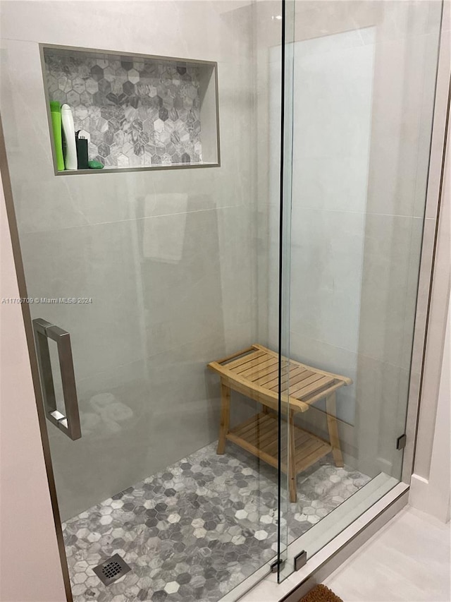 bathroom featuring a shower with door