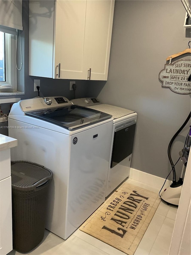 laundry area featuring cabinets and washing machine and dryer