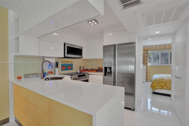 kitchen featuring white cabinets, appliances with stainless steel finishes, and sink