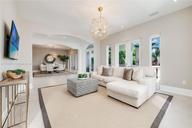 living room with a chandelier and french doors