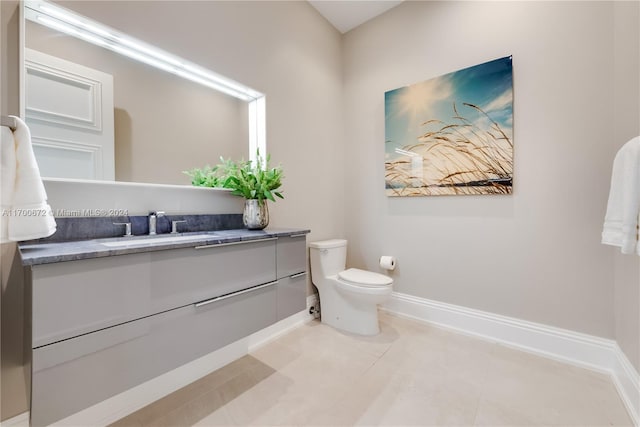 bathroom with tile patterned floors, vanity, and toilet