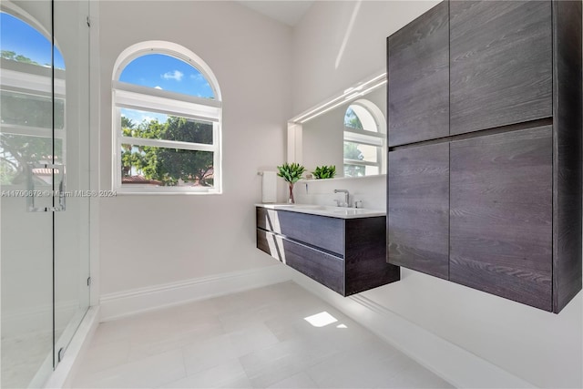 bathroom featuring tile patterned floors, a shower, and vanity