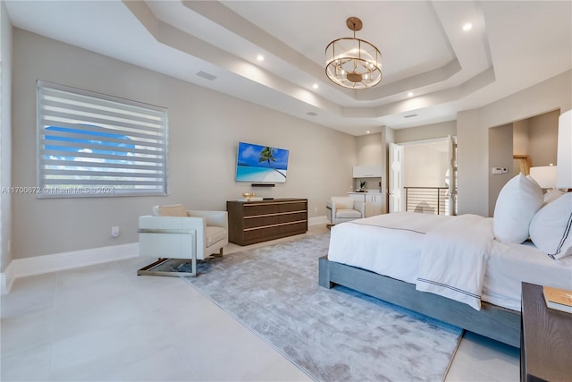 bedroom featuring a chandelier and a raised ceiling