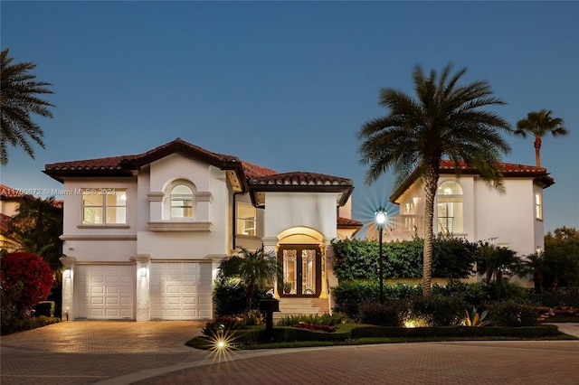 mediterranean / spanish-style house with french doors and a garage