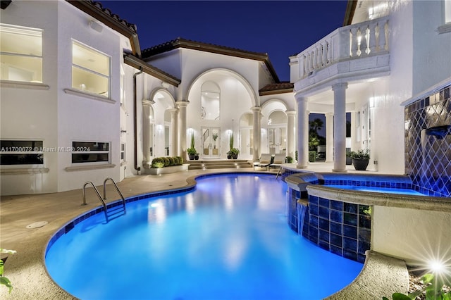 pool at twilight with a patio