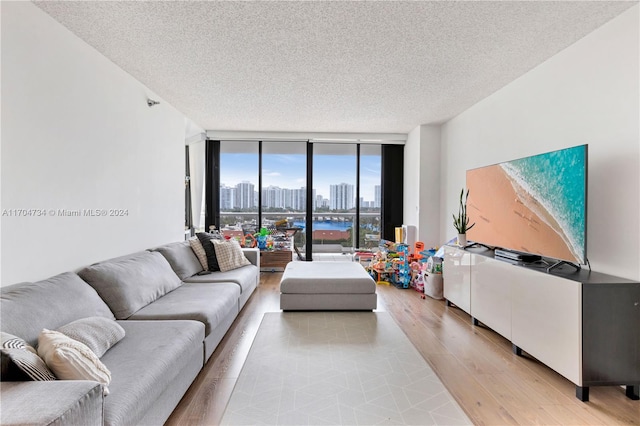 3640 Yacht Club Dr Unit 607, Aventura, FL 33180 - living area with floor to ceiling windows, a textured ceiling, and light wood-style floors