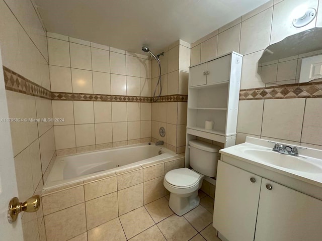 full bathroom with tile patterned flooring, vanity, tile walls, and tiled shower / bath