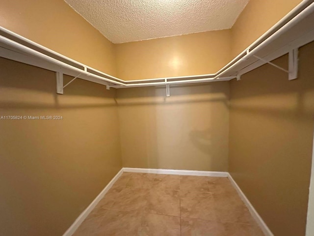 spacious closet featuring tile patterned floors