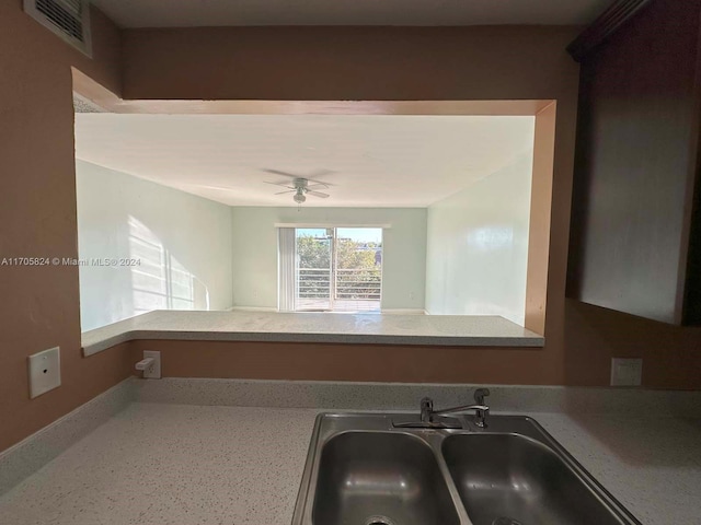 kitchen featuring ceiling fan and sink