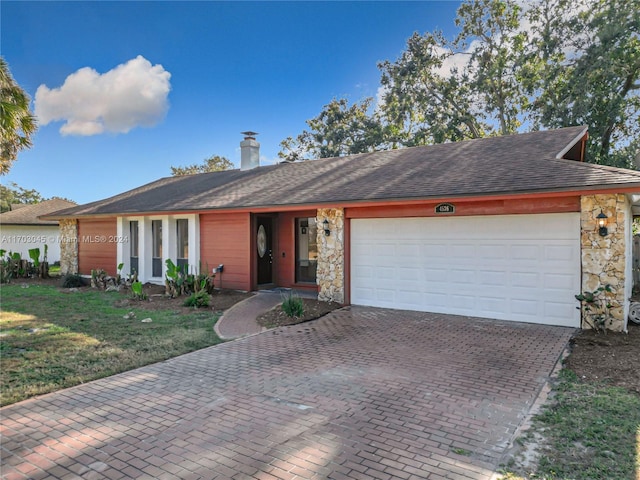 ranch-style home featuring a front yard and a garage