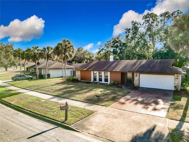 ranch-style house with a front yard and a garage