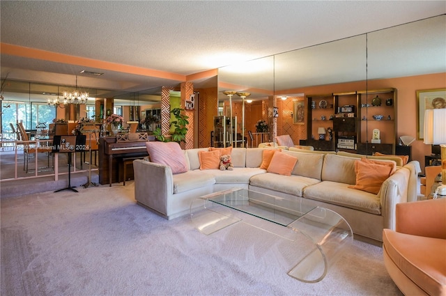 carpeted living room featuring a textured ceiling and a chandelier