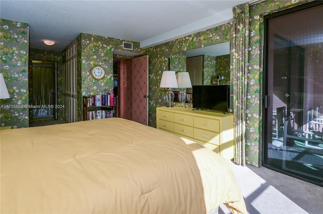 carpeted bedroom featuring a textured ceiling