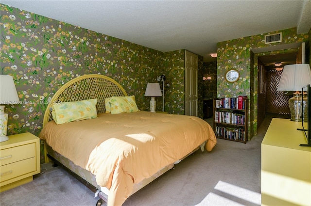 carpeted bedroom with a textured ceiling