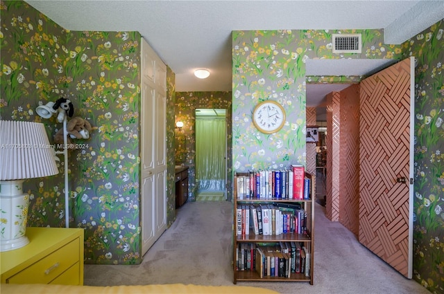 interior space with a textured ceiling and light colored carpet