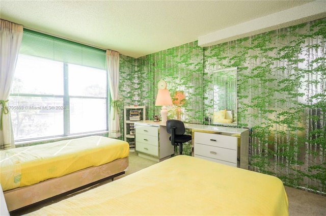 unfurnished bedroom featuring light carpet, built in desk, and a textured ceiling