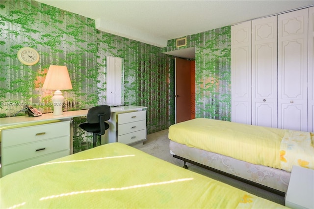 bedroom featuring light carpet and a closet