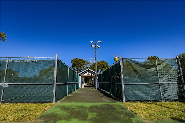 view of community featuring tennis court