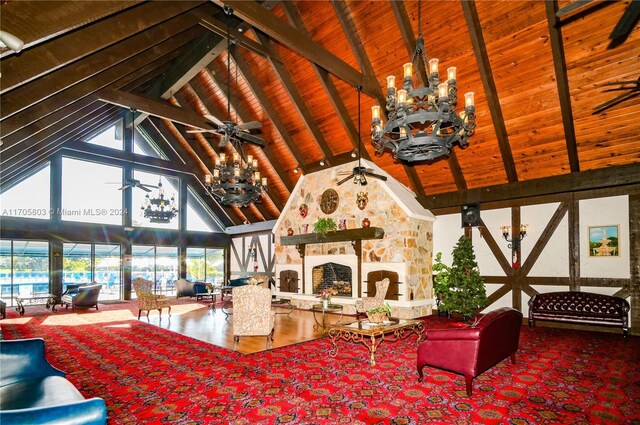 living room featuring a fireplace, hardwood / wood-style flooring, high vaulted ceiling, and beamed ceiling