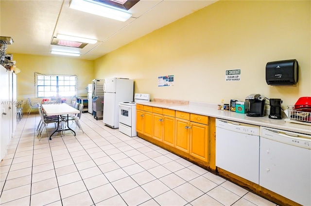 kitchen with light tile patterned flooring and white appliances